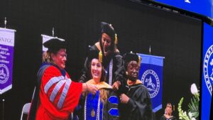 Laura Cervantes receiving her Doctor of Nursing Practice hood at Frontier Nursing University commencement